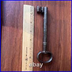 Large antique metal skeleton key with oval bow, old-style vintage key