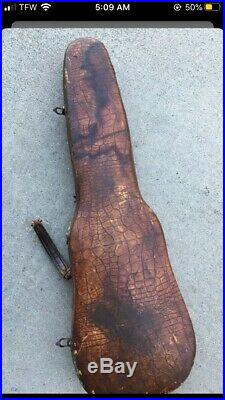 Old vintage antique violin in alligator style leather case